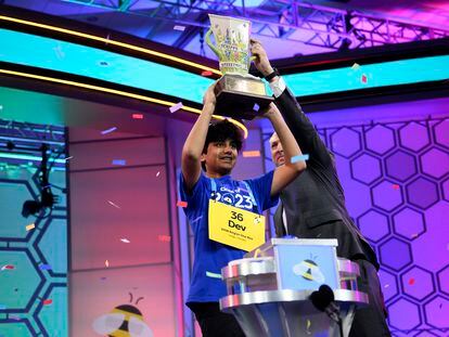 Dev Shah, 14, from Largo, Fla., lifts the trophy next to Scripps CEO Adam Symson after he won the Scripps National Spelling Bee finals, Thursday, June 1, 2023, in Oxon Hill, Md.