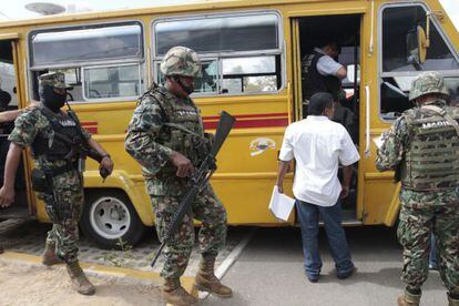 Forensic personnel and members of the Navy work at a crime scene in which a bus driver and his two assistants were killed by gunmen inside a bus in Acapulco&#039;s Cayaco neigbourhood.