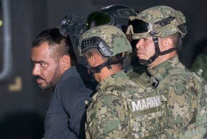 Ivan Gastelum aka "El Cholo Ivan", who is Joaquin "El Chapo" Guzman's  is escorted to a helicopter in handcuffs by Mexican navy marines