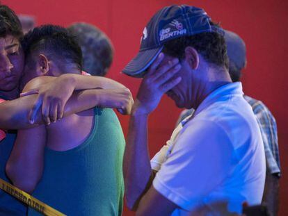 Tears and hugs after a shooting that left 23 people dead in a bar in Veracruz, Mexico last August.