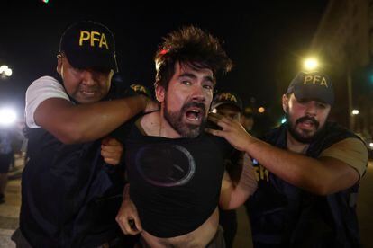 Police officers detain a demonstrator during a protest as legislative debate on Argentina's President Javier Milei's economic reform bill