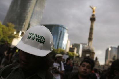 A protestor wears a hardhat that reads: &quot;Pemex is not for sale.&quot;