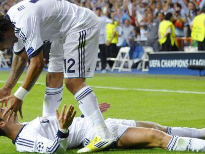 Real Madrid&#039; s Ronaldo celebrates with team mate Marcelo (top) after scoring a goal against Manchester City.