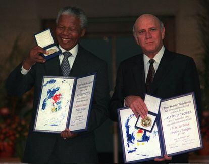 Nelson Mandela and Frederik W. de Klerk, who played key roles in ending apartheid in South Africa, pose with the Nobel Peace Prize in 1993.