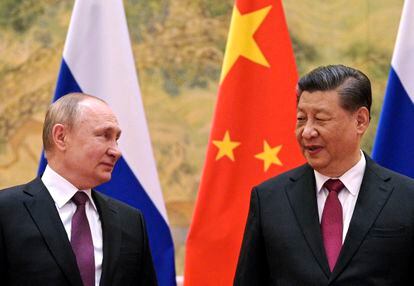 FILE - Chinese President Xi Jinping, right, and Russian President Vladimir Putin talk to each other during their meeting in Beijing, China on Feb. 4, 2022.