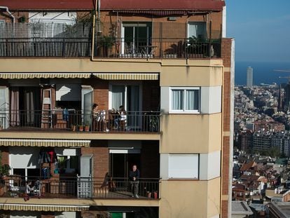 The residents of an apartment block in Barcelona sit out on their balconies during quarantine.