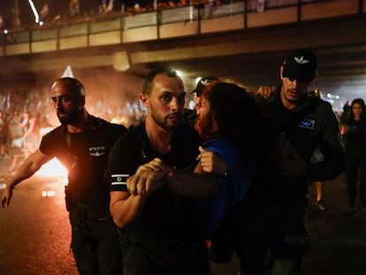 Police detain a person during a demonstration following a parliament vote on a contested bill that limits Supreme Court powers to void some government decisions, in Tel Aviv, Israel, on July 25, 2023.