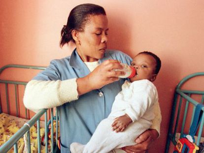 A nurse in Johannesburg feeds an HIV-infected child.