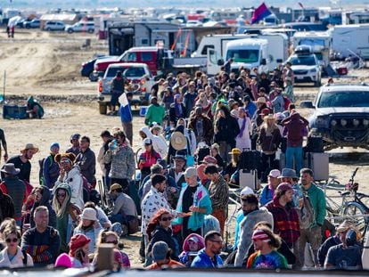 Hundreds of Burning Man attendees who planned to leave on buses wait for information about when they will be able to leave on Labor Day, after a rainstorm turned the site into mud September 4, 2023.