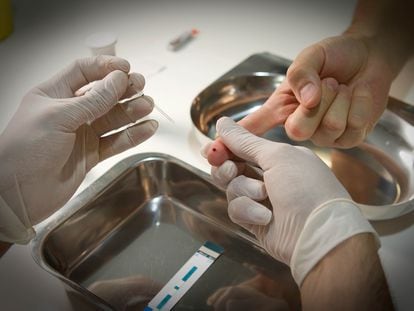 A healthcare worker carries out an HIV test in this file photo.