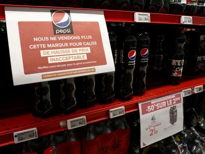 A sign reading 'We are no longer selling this brand due to unacceptable price increase' is seen on a shelf for PepsiCo product at a Carrefour hypermarket in Paris, France, January 4, 2024.