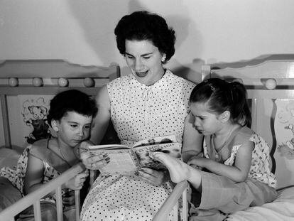 Delia Gondar reads a book to her children Delia María and Conchita before bedtime, in her home in Marianao, Cuba, around 1955.
