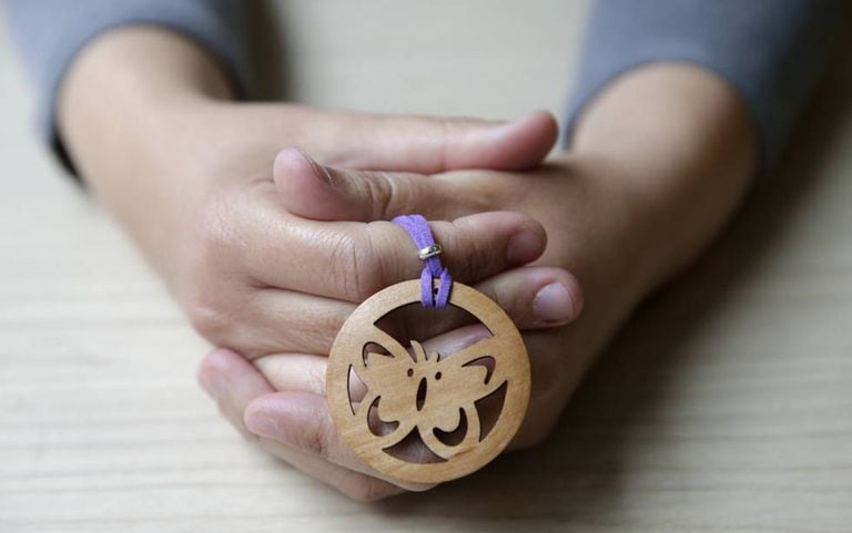 Itziar Prats holds a wooden butterfly, which was sent to her by a stranger in tribute to the victims of gender violence.