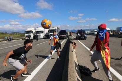 An impromptu soccer game on the C-25 road near Gurb, Catalonia on Tuesday.