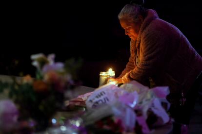 Merced Martinez places a candle at a memorial for victims of the mass shooting the day before in Half Moon Bay, Calif., Tuesday, Jan. 24, 2023.