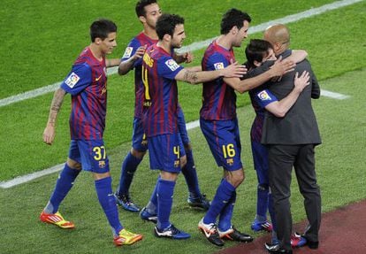 Barcelona&#039;s players celebrate with  coach Josep Guardiola after scoring a goal against Espanyol.