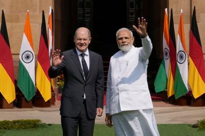 Indian Prime Minister Narendra Modi, right, with German Chancellor Olaf Scholz, wave to media before their meeting in New Delhi, India, Saturday, Feb. 25, 2023. Germany Chancellor Olaf Scholz arrived in the Indian capital on Saturday and he is expected to discuss with the Indian prime minister Russia's war in Ukraine and steps to boost bilateral cooperation in sectors such as renewables, hydrogen, mobility, pharma and digital economy, officials said. (AP Photo/Manish Swarup)