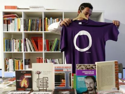 A Podemos supporter holds up one of the party’s shirts in Madrid.