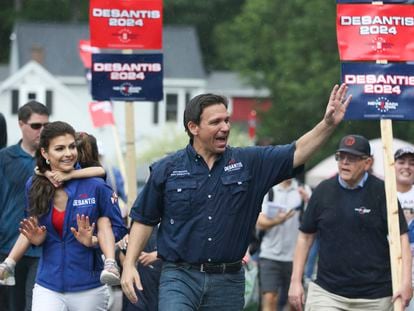 Republican presidential candidate and Florida Gov. Ron DeSantis and his wife, Casey, walk in the July 4th parade in Merrimack, New Hampshire.