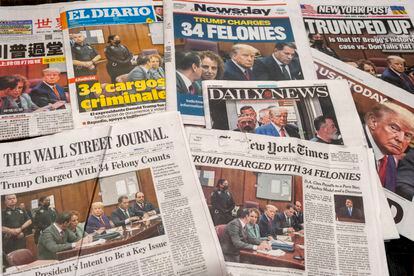 Several American newspapers bearing headlines about Donald Trump being charged with felonies, in April, 2023.