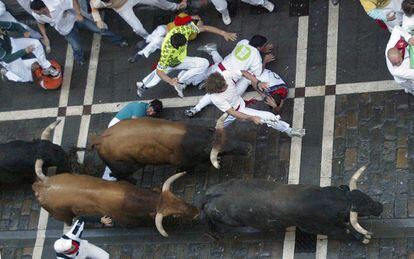 A runner is grazed by a bull’s horn on Estafeta street during the fourth bull running at Sanfermines 2005.