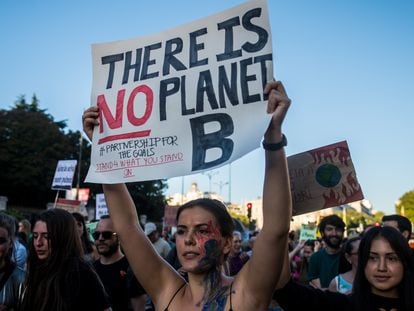 A young woman holds up a sign during a protest march, warning about the dangers of climate change, in Madrid, on September 27, 2019.