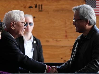Taiwan Semiconductor Manufacturing Company founder Morris Chang, left, shakes hands with Nvidia Co-founder, President, and CEO Jensen Huang, right, at the TSMC facility in Phoenix, Tuesday, Dec. 6, 2022.