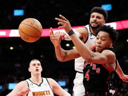 Denver Nuggets guard Jamal Murray and Toronto Raptors forward Scottie Barnes (4) vie for the ball during the first half of an NBA basketball game Tuesday, March 14, 2023, in Toronto.