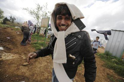 A Syrian man smiles for the camera after receiving clothes as part of a shipment of angora products donated by Inditex.