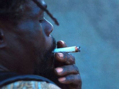 A young man smokes marijuana in Kingston, Jamaica.