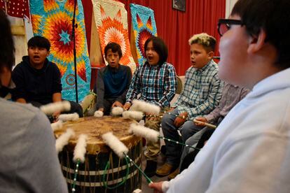 Students from Rosebud Elementary School perform in a drum circle during a meeting about abusive conditions at Native American boarding schools at Sinte Gleska University on the Rosebud Sioux Reservation in Mission, S.D., Saturday, Oct. 15, 2022