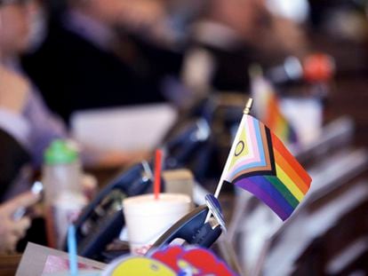 A flag supporting LGBTQ+ rights decorates a desk on the Democratic side of the Kansas House of Representatives during a debate, March 28, 2023