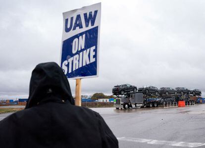 An independent contractor hauls vehicles made at the Spring Hill General Motors (GM) manufacturing plant as Union members picket General Motors