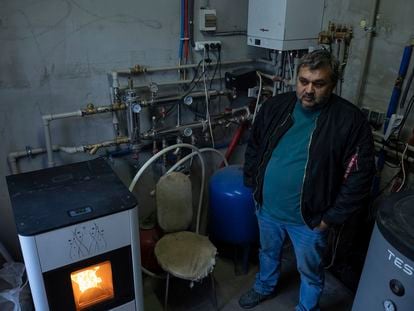 Andriy Gorghinskyyб 49, stands in his house with autonomous heating, in the village of Malyutyanka near Kyiv, Ukraine, Tuesday, Oct. 10, 2023.  Many Ukrainians are expecting the same or worse this coming winter and have spent months preparing, including collecting firewood and buying generators.(AP Photo/Alex Babenko)