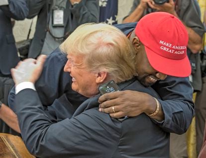 Kanye West hugs Donald Trump wearing one of Trump’s "Make America Great Again" caps.

