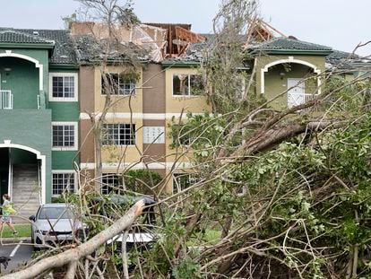 Downed trees appear near a property with a damaged roof after a reported tornado hit the area Sunday, April 30, 2023 in Palm Beach Gardens, Fla.