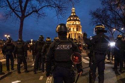  French riot police stand guard after clashes with protesters during a demonstration against the government pension reform at Vauban square in Paris.