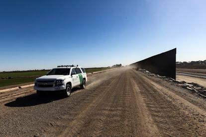 A Border Patrol truck drives along the US-Mexico border wall in Arizona.