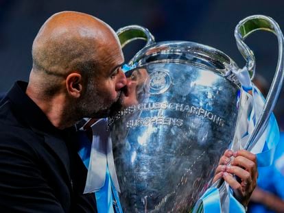 Manchester City's head coach Pep Guardiola kisses the trophy after winning the Champions League final soccer match at the Ataturk Olympic Stadium in Istanbul, Turkey, on June 11, 2023.