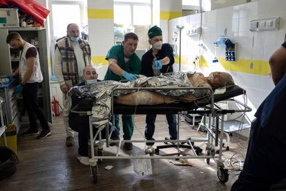 Doctors treat an injured local woman after shelling by Russian forces of residential neighbourhood at the hospital of Kostiantynivka, Ukraine, Friday, March 10.