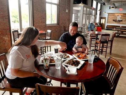 A couple eats with their young son at a restaurant in Pennsylvania.