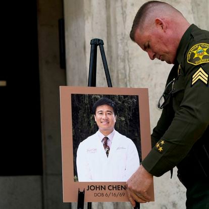 The sheriff of Orange County, Scott Steinle, with a photograph of John Cheng.