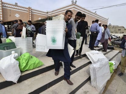 Pakistani electoral personnel transport material on the eve of the elections in Karachi, February 7.