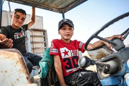 Two children on a tractor in the southern West Bank.