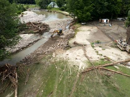 A photo made with a drone of a large backhoe clears debris from the Williams River Middle Branch behind a residential home in Chester, Vermont, USA, 13 July 2023.
