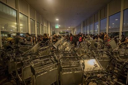 Protesters blocked the entrance with luggage carts.
