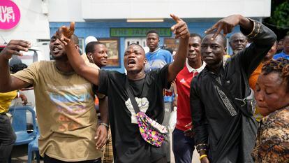 People celebrates after Eeectoral officials announce a result from of the polling station in Lagos, Nigeria, Saturday, March 18, 2023.