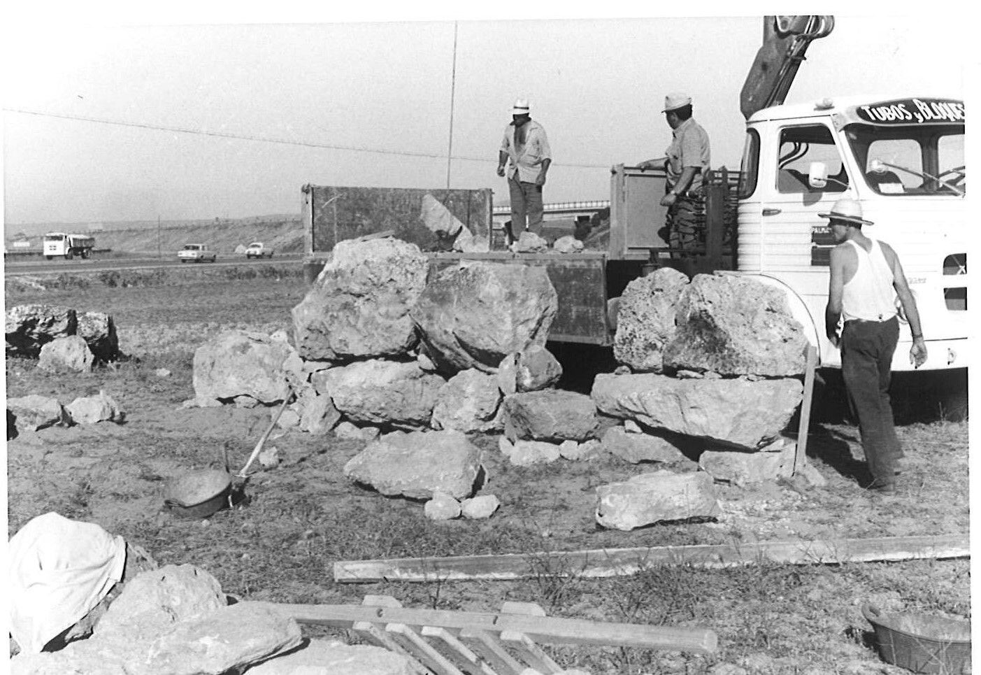Workers load the stones of the Talaiotic sanctuary at Son Oms in the late 1960s.