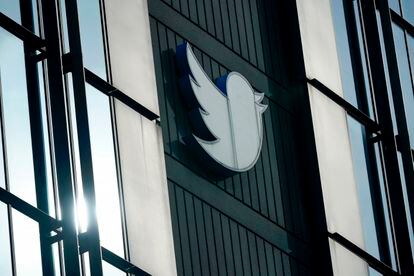 A Twitter logo hangs outside the company's offices in San Francisco, on Dec. 19, 2022