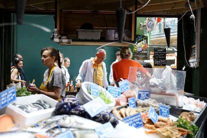 People shop at Borough Market in London, Britain July 19, 2023.